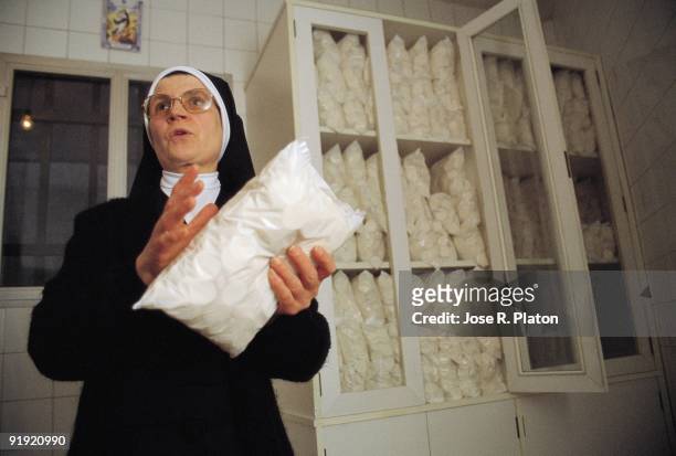 Host A nun shows a bag of Host