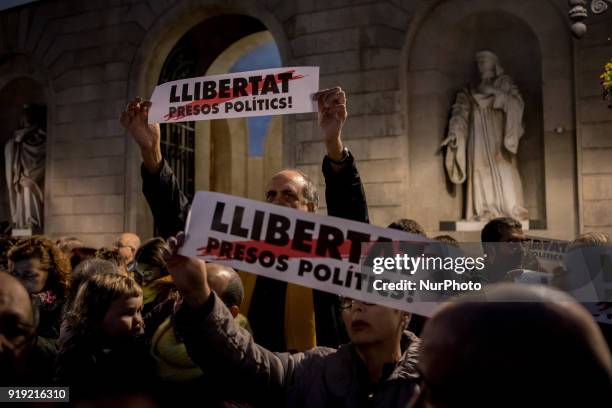 People hold banners reading 'Freedom for political prisoners' during a march in support of imprisoned Catalan independentist leaders in Barcelona,...