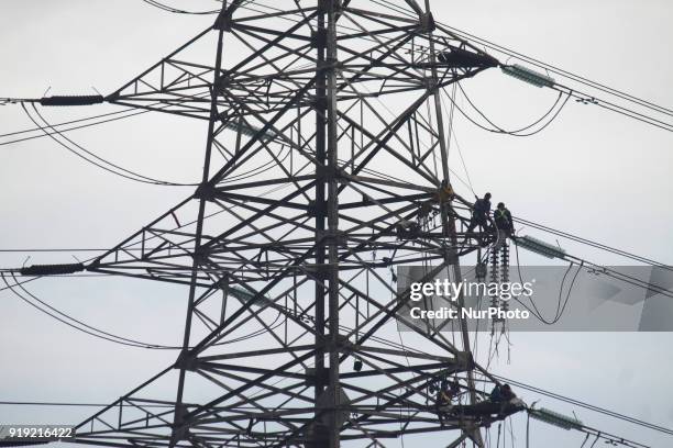 Workers assemble cables at an extra-high voltage tower in Jakarta on Friday, February 16, 2018. The construction of the 500 kv high-voltage tower as...