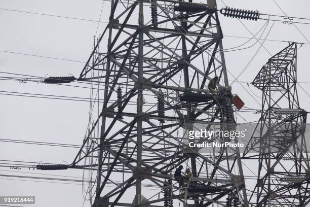Workers assemble cables at an extra-high voltage tower in Jakarta on Friday, February 16, 2018. The construction of the 500 kv high-voltage tower as...