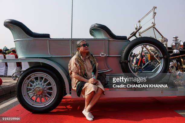 Visitor sits on a 1913 Rolls Royce Silver Ghost at the '21 Gun Salute International Vintage Car Rally and Concours Show' in New Delhi on February 17,...