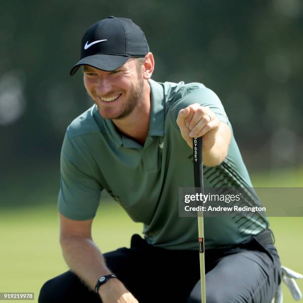 Chris Wood of England lines up his putt on the first green during the third round of the NBO Oman Open at Al Mouj Golf on February 17, 2018 in...