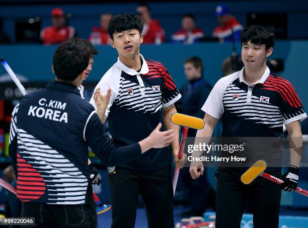 KiBok Lee and EunSu Oh of South Korea celebrate the throw of ChangMin Kim to score three in the eighth end, enroute to a 11-5 win over Great Britain...