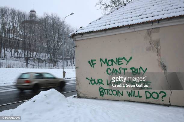 Graffiti on the outskirts of the city center reads: "If money can't buy your love, maybe Bitcoin will do?" in an interpretation of a famous line from...