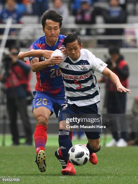 Takuya Kida of Yokohama F.Marinos and Ryoichi Maeda of FC Tokyo compete for the ball during the preseason friendly match between FC Tokyo and...