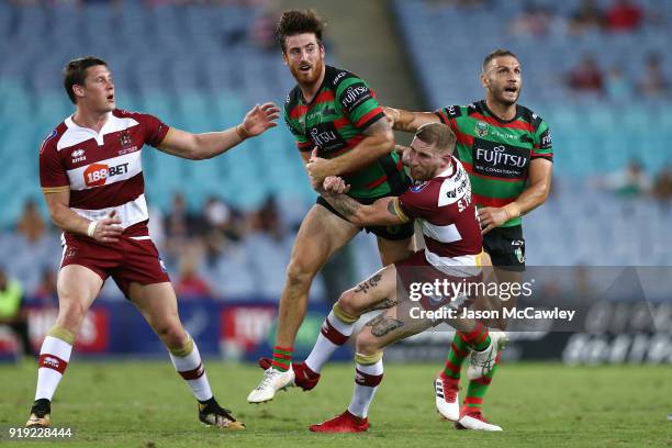 Dean Britt of the Rabbitohs is tackled by Sam Tomkins of Wigan during the NRL trial match between the South Sydney Rabbitohs and Wigan at ANZ Stadium...