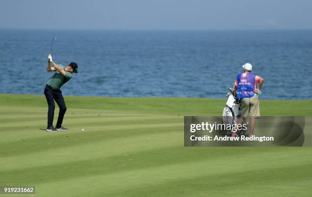 Chris Wood of England hits his second shot on the par four 9th hole during the third round of the NBO Oman Open at Al Mouj Golf on February 17, 2018...