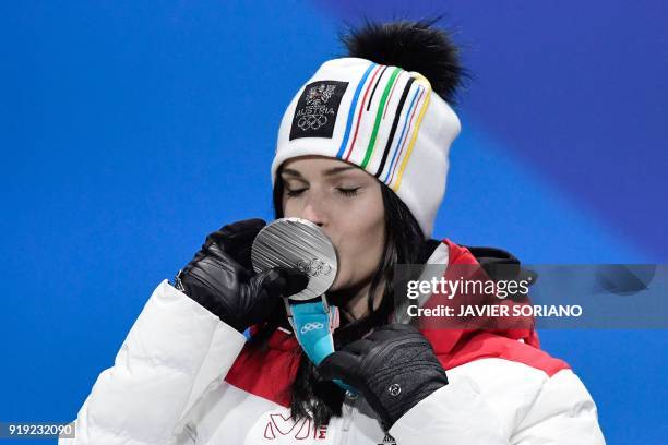 Austria's silver medallist Anna Fenninger Veith kisses her medal on the podium during the medal ceremony for the alpine skiing women's Super-G at the...