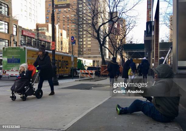 Homeless person panhandles during freezing temperatures at the 5th Avenue in New York, United States on February 16, 2018. On winter, thousands of...