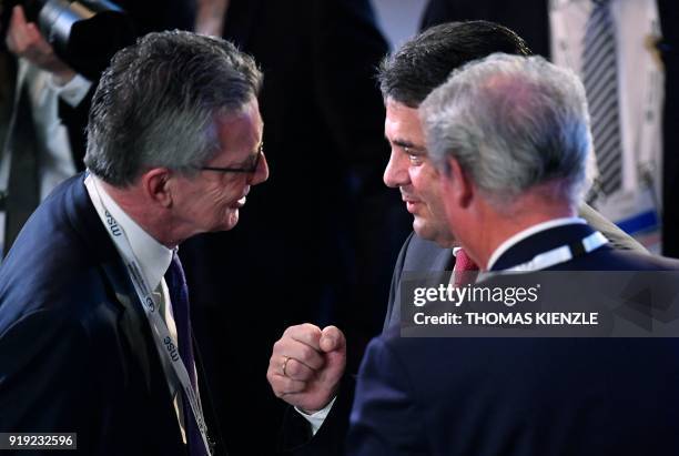 German Foreign Minister Sigmar Gabriel talks with German Interior Minister Thomas de Maiziere during the Munich Security Conference on February 17,...