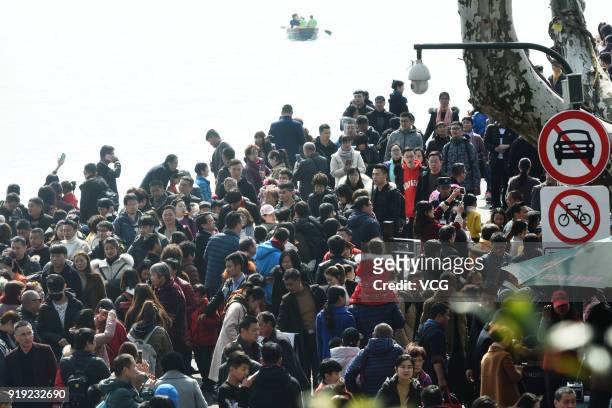 Tourists flock to the Broken Bridge on West Lake on the second day of Spring Festival on February 17, 2018 in Hangzhou, Zhejiang Province of...
