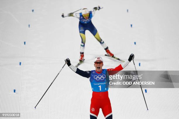 Norway's Marit Bjorgen crosses the finish line first during the women's 4x5km classic free style cross country relay at the Alpensia cross country...