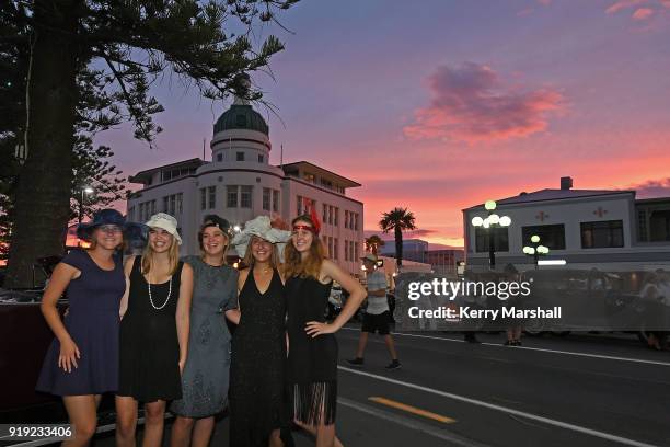 People in costume pose for photos as the sun sets during the Art Deco Festival on February 17, 2018 in Napier, New Zealand. The annual five day...