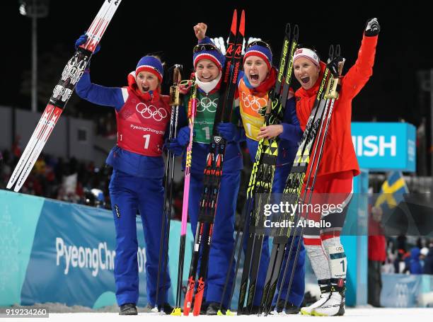 Gold medalists Ingvild Flugstad Oestberg, Astrid Uhrenholdt Jacobsen, Ragnhild Haga and Marit Bjoergen of Norway celebrate after the Ladies' 4x5km...