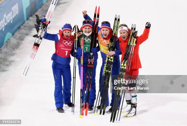 Gold medalists Ingvild Flugstad Oestberg, Astrid Uhrenholdt Jacobsen, Ragnhild Haga and Marit Bjoergen of Norway celebrate after the Ladies' 4x5km...