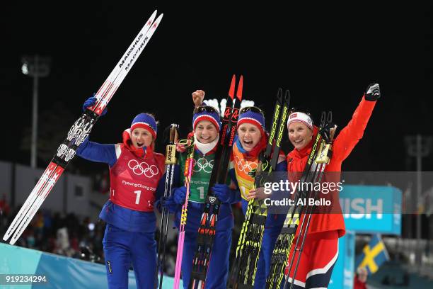 Gold medalists Ingvild Flugstad Oestberg, Astrid Uhrenholdt Jacobsen, Ragnhild Haga and Marit Bjoergen of Norway celebrate after the Ladies' 4x5km...