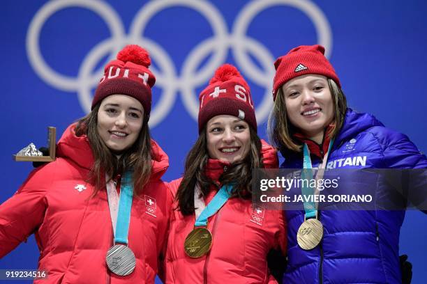 Switzerland's silver medallist Mathilde Gremaud, Switzerland's gold medallist Sarah Hoefflin and Britain's bronze medallist Isabel Atkin pose on the...
