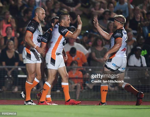 Josh Reynolds of the Tigers celebrates the try of Corey Thompson during the NRL trial match between the North Queensland Cowboys and the Wests Tigers...
