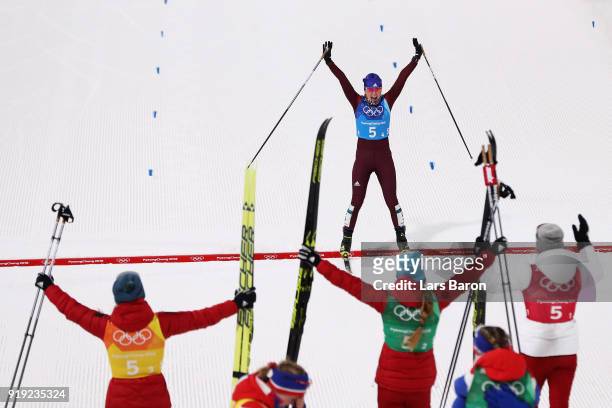 Anna Nechaevskaya of Olympic Athlete from Russia crosses the finish line to be greeted by team mates Anastasia Sedova, Yulia Belorukova and Natalia...