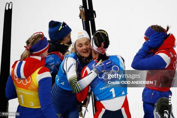 Norway's Marit Bjorgen is congratulaed by Sweden's Stina Nilsson after the women's 4x5km classic free style cross country relay at the Alpensia cross...