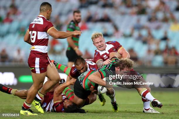 George Burgess of the Rabbitohs is tackled during the NRL trial match between the South Sydney Rabbitohs and Wigan at ANZ Stadium on February 17,...