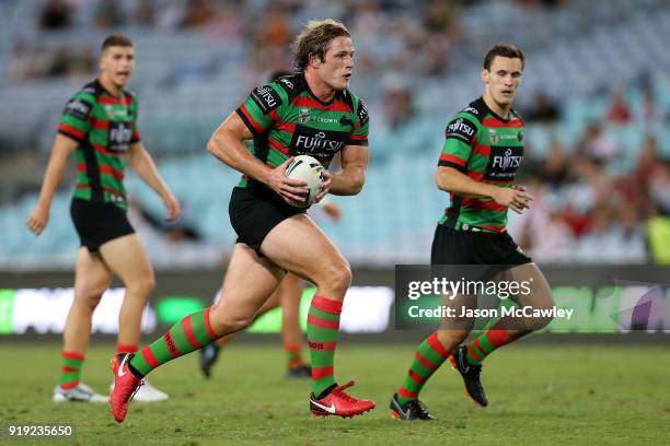 George Burgess of the Rabbitohs runs with the ball during the NRL trial match between the South Sydney Rabbitohs and Wigan at ANZ Stadium on February...