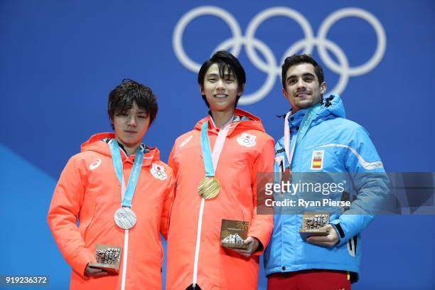 Silver medalist Shoma Uno of Japan, gold medalist Yuzuru Hanyu of Japan and bronze medalist Javier Fernandez of Spain celebrate during the medal...