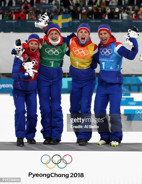 Gold medalists Ingvild Flugstad Oestberg, Astrid Uhrenholdt Jacobsen, Ragnhild Haga and Marit Bjoergen of Norway celebrate during the victory...