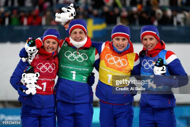 Gold medalists Ingvild Flugstad Oestberg, Astrid Uhrenholdt Jacobsen, Ragnhild Haga and Marit Bjoergen of Norway celebrate during the victory...