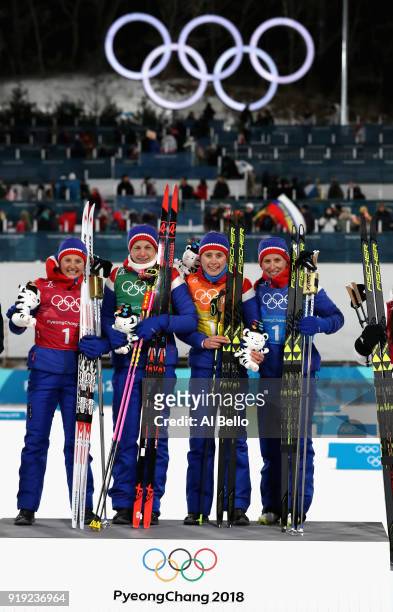 Gold medalists Ingvild Flugstad Oestberg, Astrid Uhrenholdt Jacobsen, Ragnhild Haga and Marit Bjoergen of Norway celebrate during the victory...
