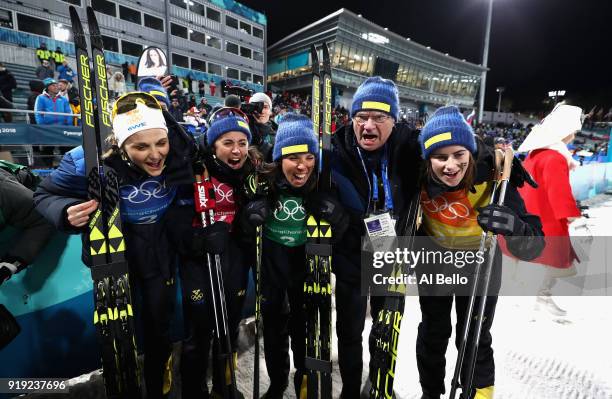 Silver medalists Stina Nilsson, Ebba Andersson, Charlotte Kalla and Anna Haag of Sweden celebrate with King Carl Gustaf of Sweden after the Ladies'...