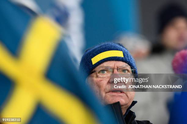 Carl Gustaf, King of Sweden cheers on his country's team during the women's 4x5km classic free style cross country relay at the Alpensia cross...