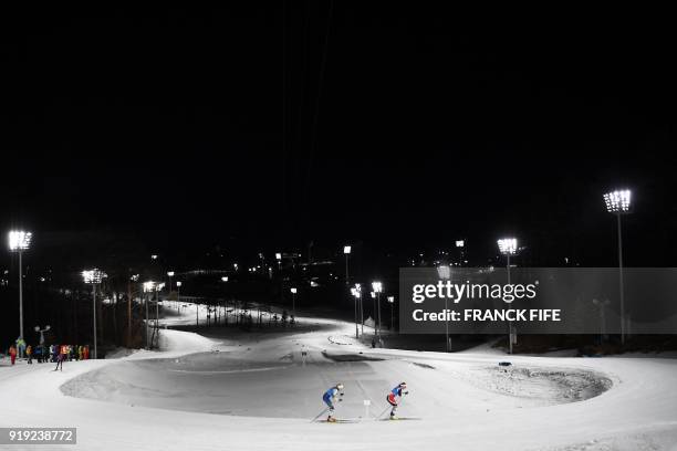 Norway's Marit Bjorgen leads ahead of Sweden's Stina Nilsson during the women's 4x5km classic free style cross country relay at the Alpensia cross...