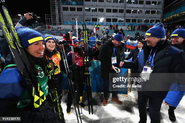 Silver medalists Ebba Andersson, Charlotte Kalla and Anna Haag of Sweden celebrate with King Carl Gustaf of Sweden after the Ladies' 4x5km Relay on...