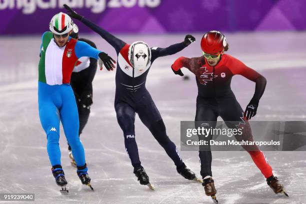 Samuel Girard of Canada, Yuri Confortola of Italy, Itzhak De Laat of the Netherlands and Kazuki Yoshinaga of Japan reach for the finish line during...