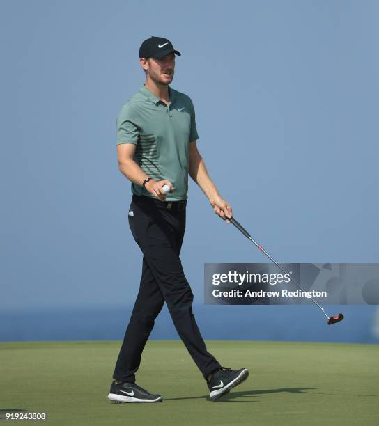 Chris Wood of England waves to the crowd the ninth green during the third round of the NBO Oman Open at Al Mouj Golf on February 17, 2018 in Muscat,...