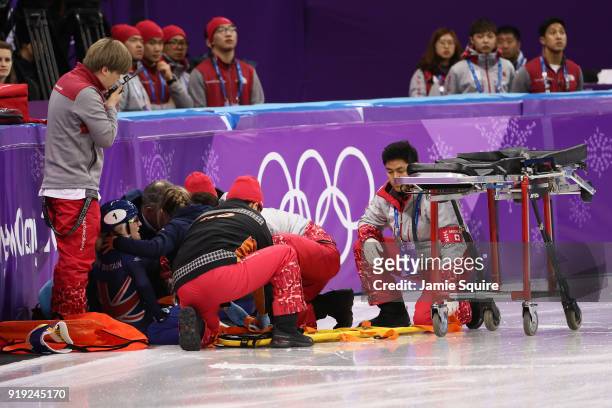 Elise Christie of Great Britain is tended to after a fall with Jinyu Li of China during the Short Track Speed Skating Ladies' 1500m Semifinals on day...