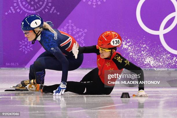 Britain's Elise Christie and China's Li Jinyu crash in the women's 1,500m short track speed skating semi-final event during the Pyeongchang 2018...