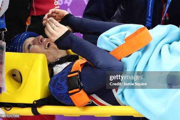 Elise Christie of Great Britain is carted off the ice on a stretcher after a crash with Jinyu Li of China during the Short Track Speed Skating...