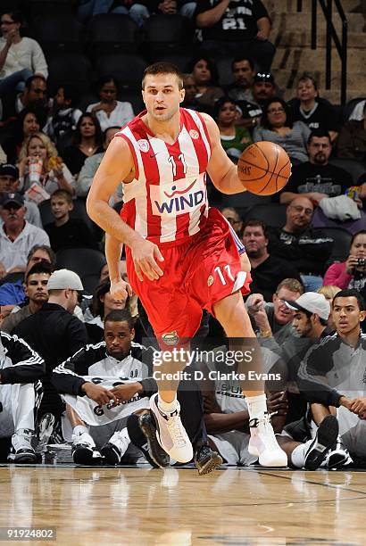 Linas Kleiza of the Greece Olympiacos drives the ball up court during the exhibition game against the San Antonio Spurs on October 9, 2009 at the...