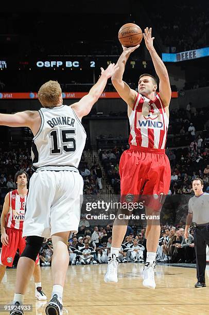 Linas Kleiza of the Greece Olympiacos shoots a jumper against Matt Bonner of the San Antonio Spurs during the exhibition game on October 9, 2009 at...