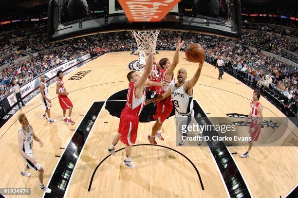 Tony Parker of the San Antonio Spurs lays up a shot against Linas Kleiza of the Greece Olympiacos during the exhibition game on October 9, 2009 at...