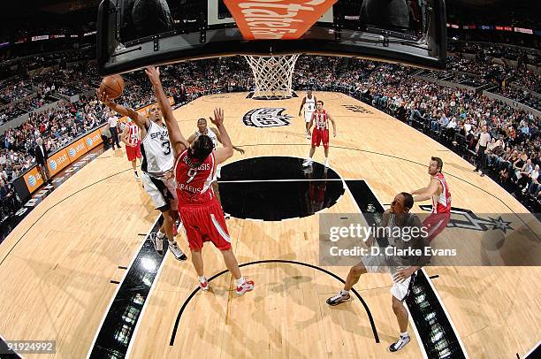 George Hill of the San Antonio Spurs lays up a shot against Ioannis Bourousis of the Greece Olympiacos during the exhibition game on October 9, 2009...