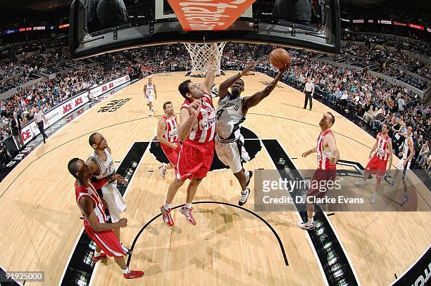 Michael Finley of the San Antonio Spurs lays up a shot against Ioannis Bourousis of the Greece Olympiacos during the exhibition game on October 9,...