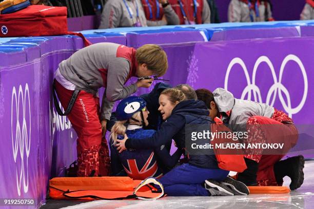 Britain's Elise Christie receives medical attention after a crash in the women's 1,500m short track speed skating semi-final event during the...