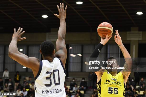 Josh Harrellson of the Sunrockers Shibuya shoots while under pressure from Hilton Armstrong of the Ryukyu Golden Kings during the B.League match...