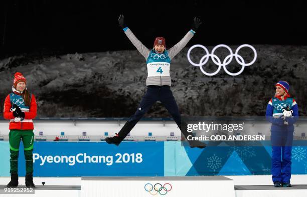 Belarus' Darya Domracheva, Slovakia's Anastasiya Kuzmina and Norway's Tiril Eckhoff celebrate on the podium during the victory ceremony after the...