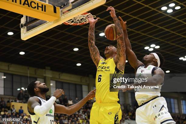 Robert Sacre of the Sunrockers Shibuya contests a rebound with Ira Brown and Hassan Martin of the Ryukyu Golden Kings during the B.League match...