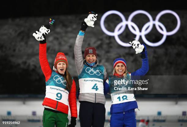 Silver medalist Darya Domracheva of Belarus, gold medalist Anastasiya Kuzmina of Slovakia and bronze medalist Tiril Eckhoff of Norway celebrate on...