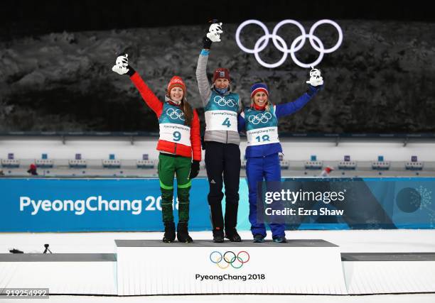 Silver medalist Darya Domracheva of Belarus, gold medalist Anastasiya Kuzmina of Slovakia and bronze medalist Tiril Eckhoff of Norway celebrate on...